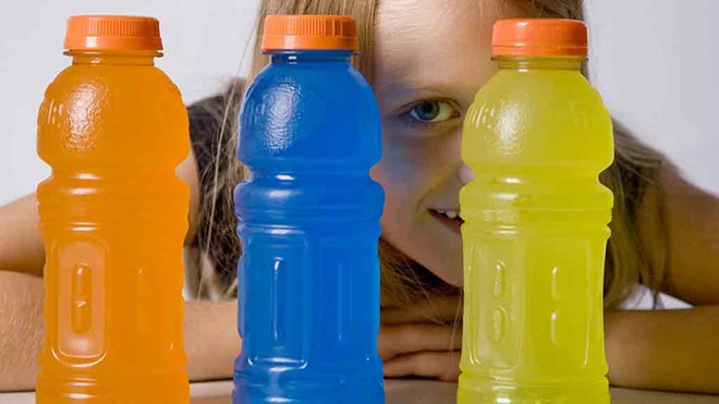 girl looking through bottles of sports drink